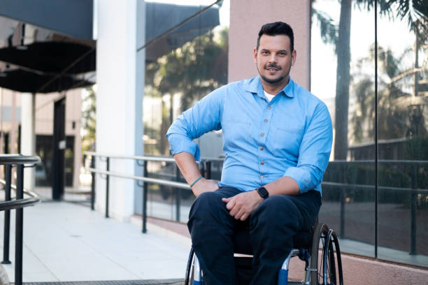 istock Man using wheelchair in front of an office building. 1435674543