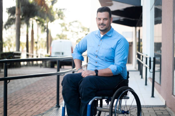 istock Man using wheelchair in front of an office building. 1435674559