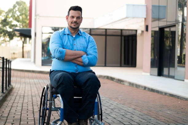 istock Man using wheelchair in front of an office building. 1435674582