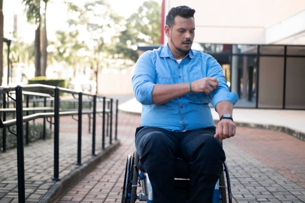 istock Man using wheelchair in front of an office building. 1435674585