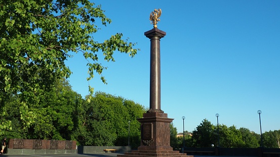 Petrozavodsk, Karelia, August 3, 2022 Monument-stele City of military glory, honorary title. Granite column with a bronze double-headed eagle. Pedestal on the alley of sister cities, Kirov Square.