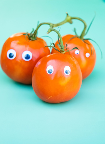 A silly tomato concept with googly eyes and faces.