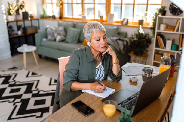 istock Senior woman using laptop at home. 1435695377