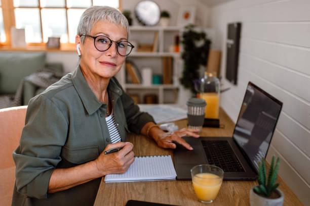 istock Senior woman has online class at home, using laptop. 1435695432
