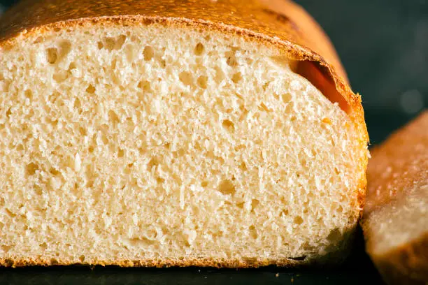 Pain de mie is a loaf of white bread with a thin, soft crust. It is mostly sold sliced and packaged. Pain is the French word for bread, and la mie is the soft part of bread, called the crumb in English. Pain de mie is most similar to a Pullman loaf, or to regular sandwich bread.