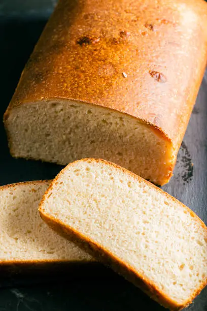 Pain de mie is a loaf of white bread with a thin, soft crust. It is mostly sold sliced and packaged. Pain is the French word for bread, and la mie is the soft part of bread, called the crumb in English. Pain de mie is most similar to a Pullman loaf, or to regular sandwich bread.