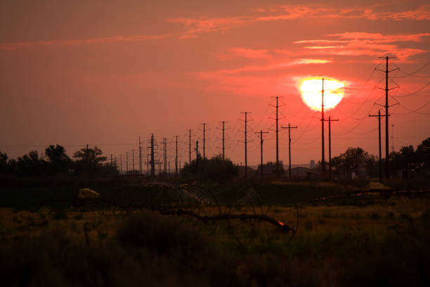 irrigation and power line sunset - idaho landscape power equipment electricity pylon imagens e fotografias de stock