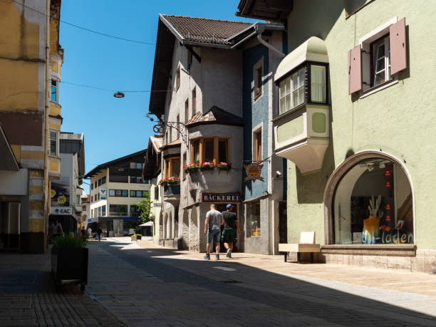 Telfs, Street view in a town in Tyrol with small businesses in the pedestrian zone. The beautiful Austrian architecture is a travel destination in Europe. Tourists are there.