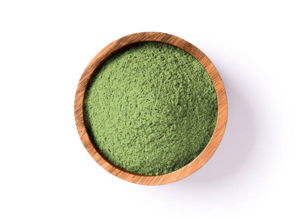 Green herbal protein powder Green herbal protein powder in wooden bowl isolated on white background. Clipping path. Top view. Flat lay. green tea powder stock pictures, royalty-free photos & images