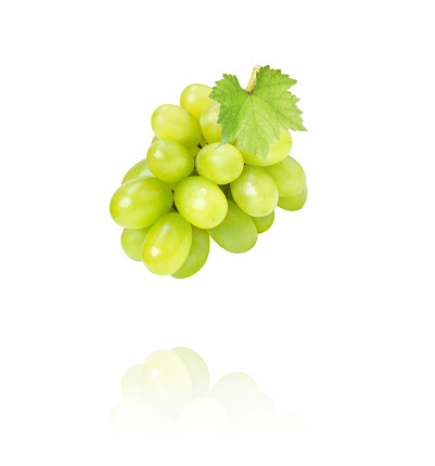 bunch of white grapes isolated against white