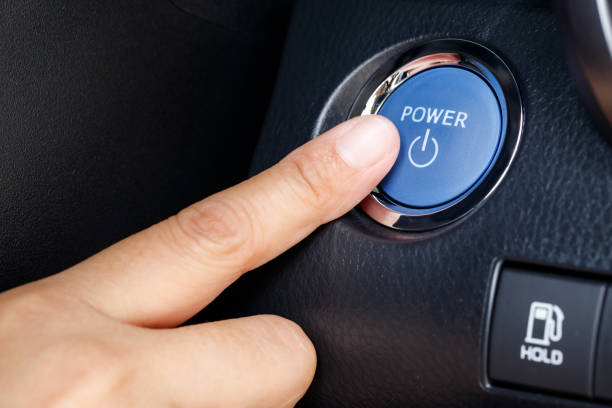 istock Finger pushing on power button to start keyless ignition hybrid car electro engine 1435729166