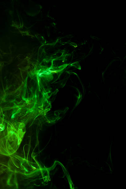 istock Green smoke motion on black background. 1435731403