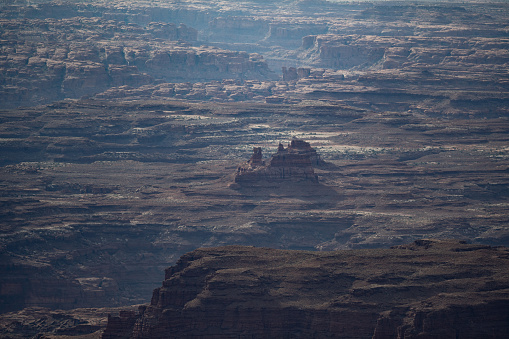 Aerial view overlooking The Maze containing deep canyons, plain deserts and mountain ranges in Canyonlands National Park, Utah, USA.