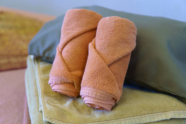 Green towels on the massage table in beauty salon. No people