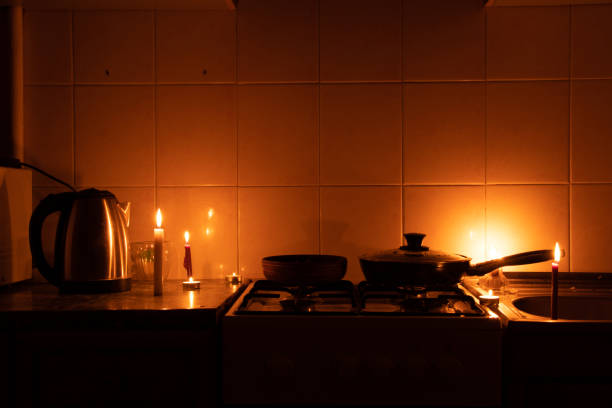 Apartment without electricity, kitchen by candlelight, Ukraine without electricity due to the war, in the dark 2022 stock photo