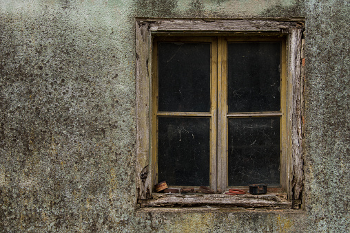 Croatia, October 20,2022 : Rustic style aged window at rural home wall.