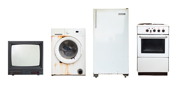 Old household appliances TV, washing machine, refrigerator, electric stove isolated on white background.