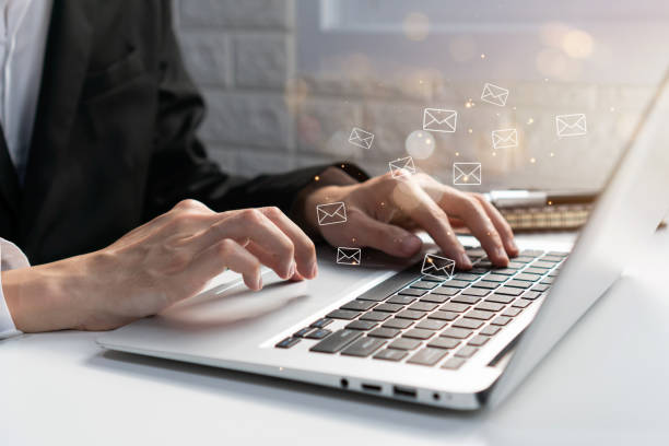 istock Businessman checking or sending online message on laptop with e-mail icons on background. Email marketing and newsletter, technology and lifestyle concept. Close up, copy space 1435766912