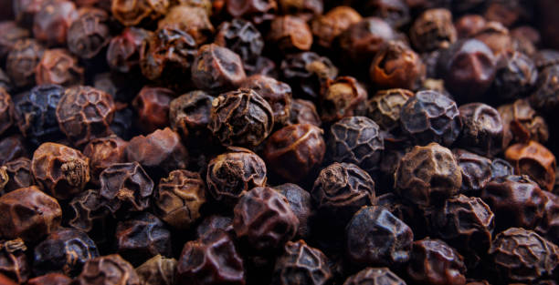 istock Black pepper grains as background close up 1435774710