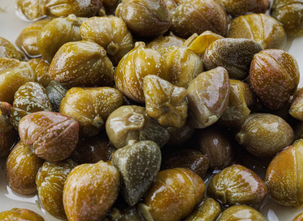 istock Background of beautiful pickled capers. Capers in brine. 1435774824