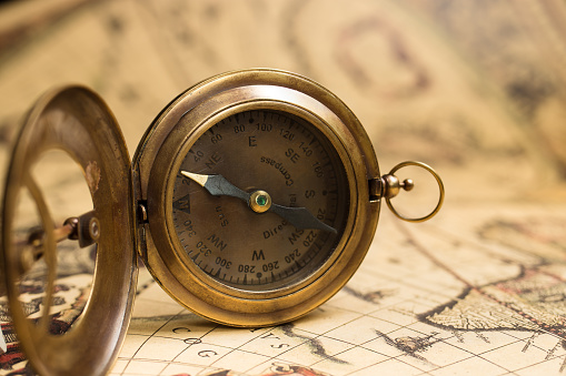 Vintage compass with sundial on old map. Adventure retro style.