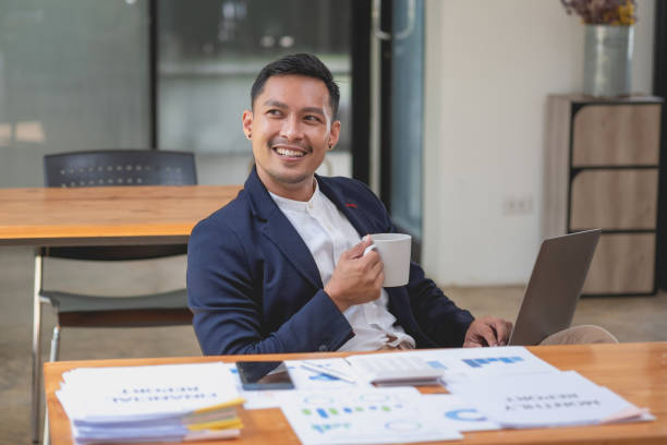 istock Team of business use calculators and graph analysis computer laptop tablets to plan marketing strategies and make profitable investments for the company. 1435779745