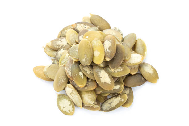 istock Pumpkin seeds on white background. Green pepita seeds. 1435779801