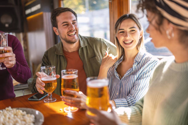 istock Group of friends cheering in a bar 1435783900