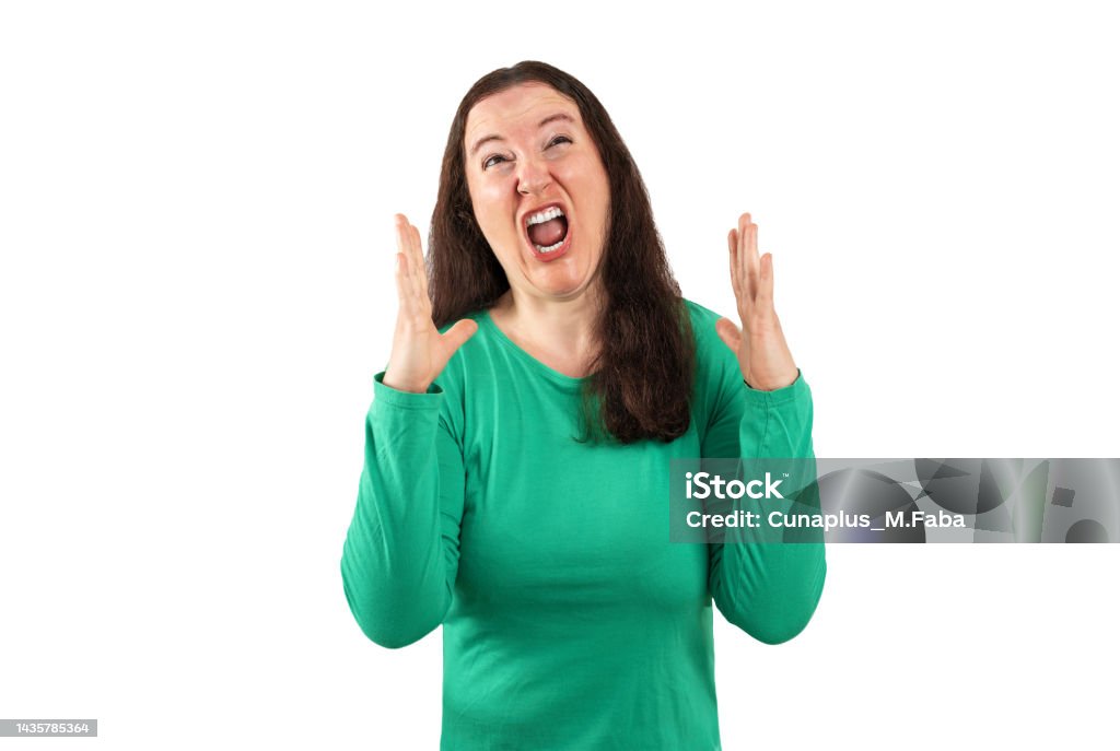 angry woman shouting out louds Middle age beautiful woman wearing t-shirt over isolated white background crazy and mad shouting and yelling with aggressive expression and arms raised. Frustration concept. Crisis Stock Photo