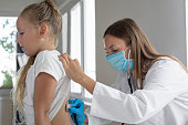 istock Female doctor listen to child back at checkup 1435796115