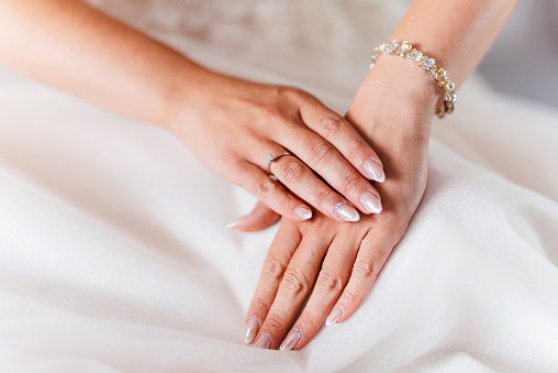 Bride's hands with an engagement ring on them