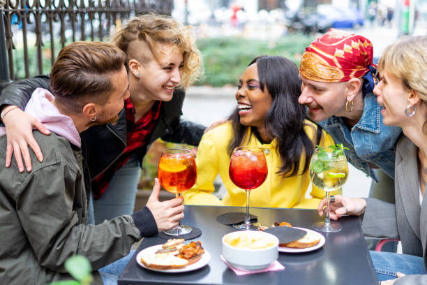 istock Happy young friends toasting with drinks together at cocktail bar . 1435810703