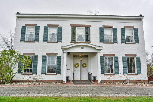 Newtonville, New York, United States of America - April 26, 2017. Pruyn House, a historic home located in Newtonville in Albany County, New York. It was built between 1824 and 1836 and combines late Federal and early Greek Revival style. It is a two-story, rectangular five bay wide, center entrance dwelling. It is open to the public as the historical and cultural arts center for the Town of Colonie.