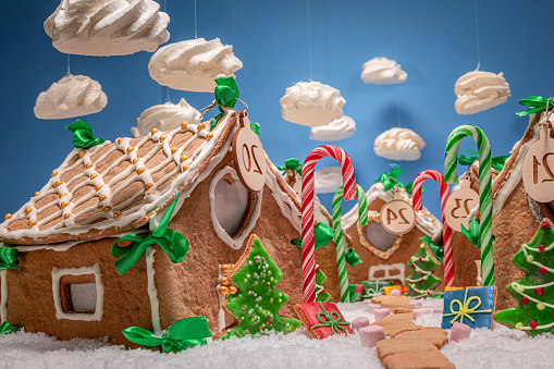 Beautiful and lovely Christmas gingerbread village with meringue clouds. Gingerbread village for Christmas.