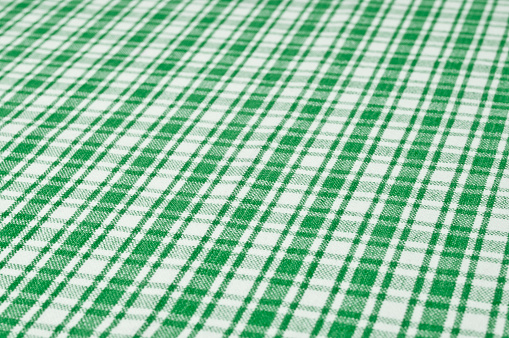 Close-up of a green and white patterned tablecloth