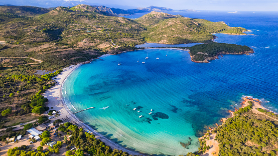Best beaches of Corsica island - aerial panoramic view of beautiful Rondinara beach with perfect round shape and crystal turquoise sea.