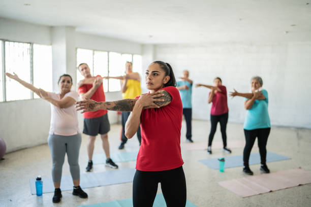 istock Yoga instructor stretching with students at the studio 1435828889