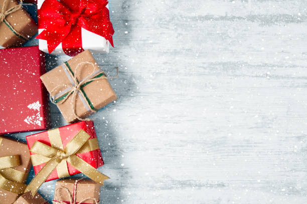istock Christmas Gifts on White Wooden Table 1435829406