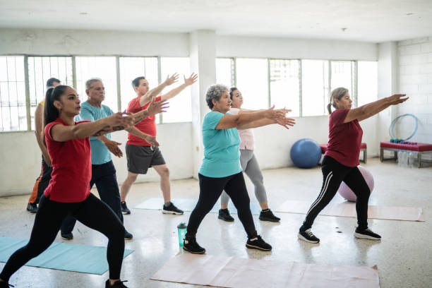 istock Yoga instructor stretching with students at the studio 1435829975
