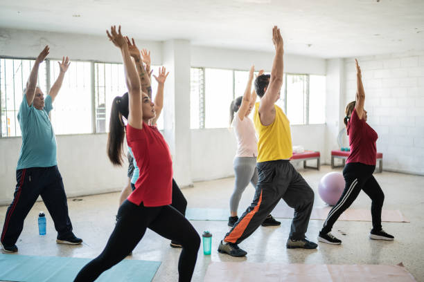 istock Yoga instructor stretching with students at the studio 1435829979