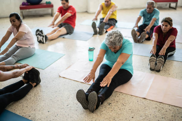 istock Senior woman stretching in a yoga class at the studio 1435830070