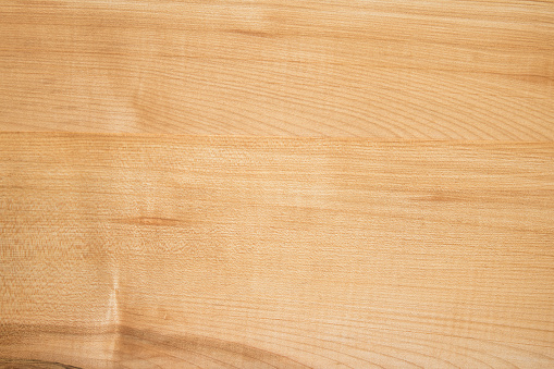 Texture of light maple boards covered with linseed oil.