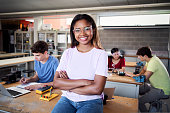 istock Portrait of a latina in the classroom looking at the camera with her arms crossed. Young students doing technical vocational practice in electronic class, Concept of education and technology. 1435831599