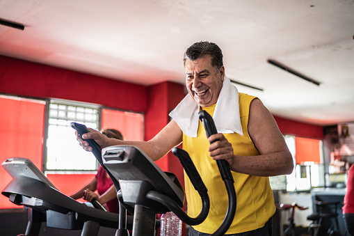 Senior man exercising on a treadmill at the gym