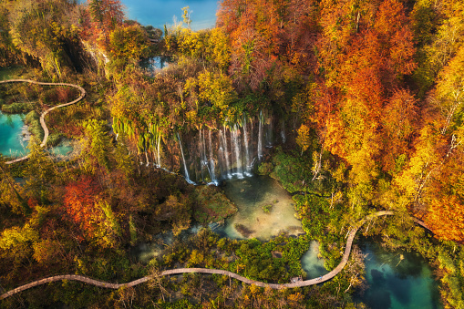 Aerial view beautiful colorful majestic waterfall in national park autumn forest top view, Plitvice lakes, Slovenia