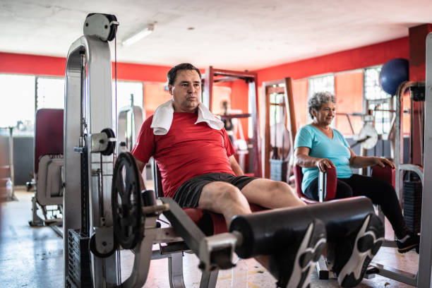 istock Mature man doing strength workout exercise in the gym 1435831827