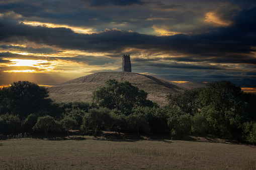 Digitally enhanced low angle sunset view of Glastonbury Tor in Somerset, England