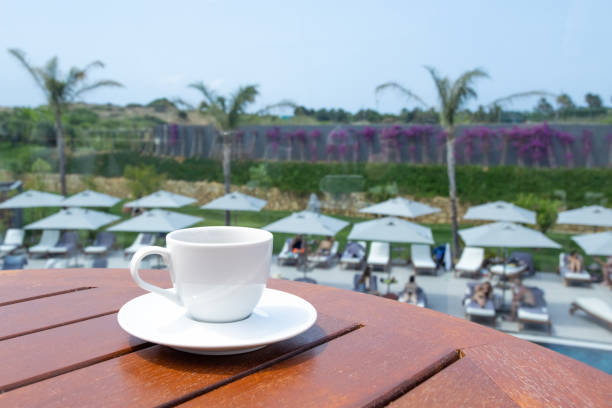 Modern espresso coffee on table, hotel vacation, great design for any purposes. Relaxation and sun concept. Natural aroma drink. Summer background.