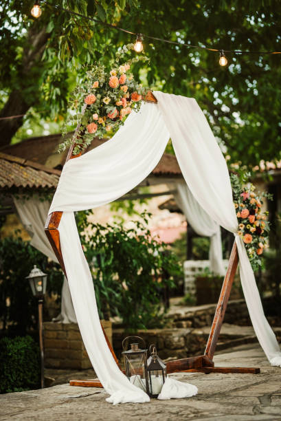 istock Beautiful wedding arch decorated with fresh flowers 1435837086