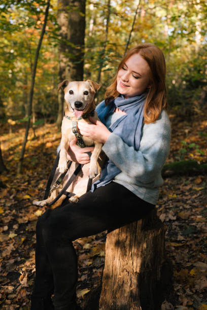 istock Young redheaded woman hugs her mixed-breed dog 1435837593